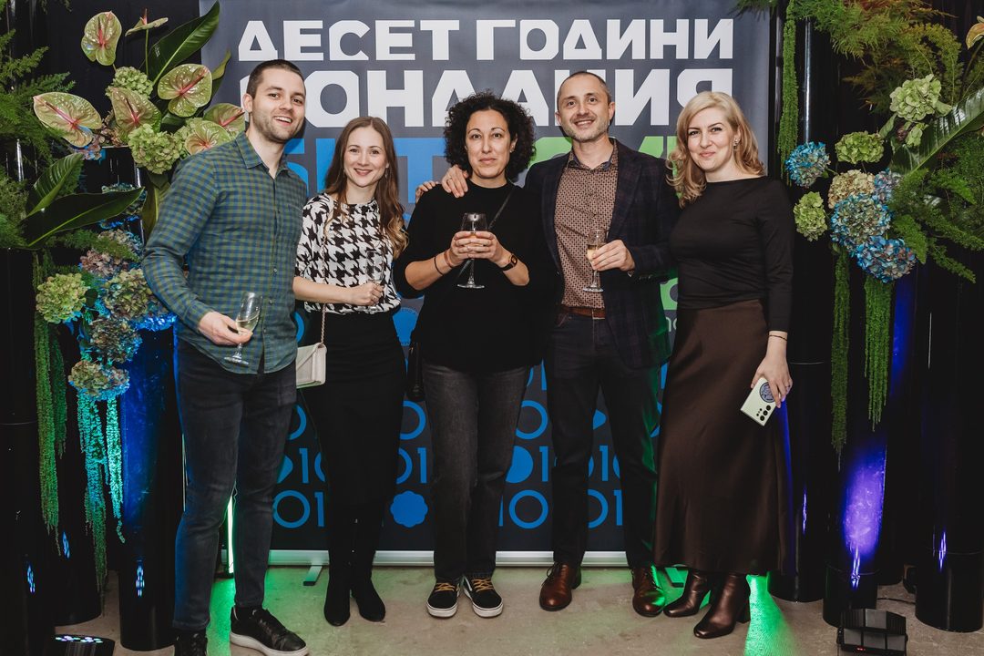 Founder Vladislav Dramaliev with a group of friends raising champagne at the Bithope Foundation 10-year anniversary toast in Sofia.