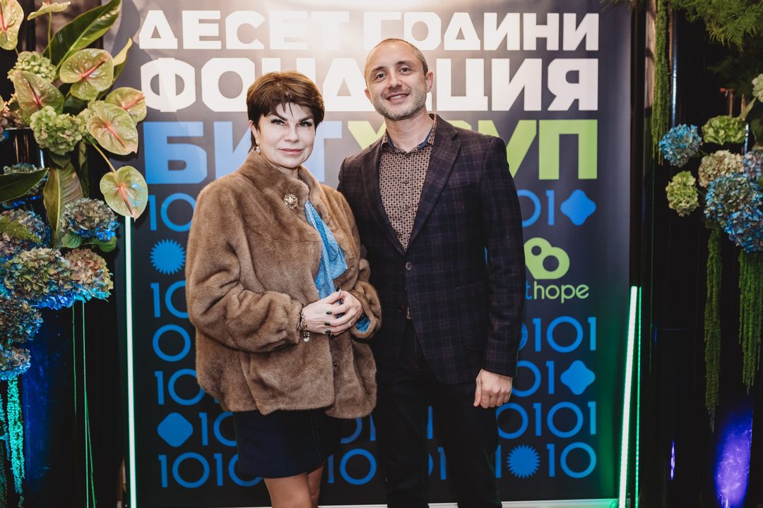 Founder Vladislav Dramaliev with a partner of the Foundation in front of the Bithope 10-year anniversary backdrop in Sofia.