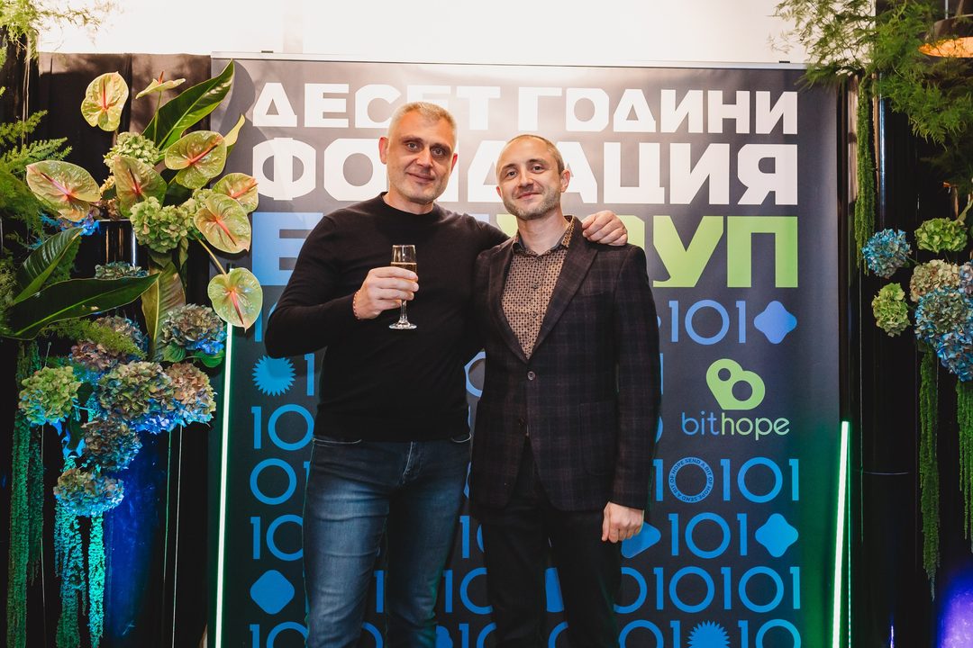 Founder Vladislav Dramaliev with a longtime supporter in front of the Bithope Foundation 10-year anniversary backdrop in Sofia.